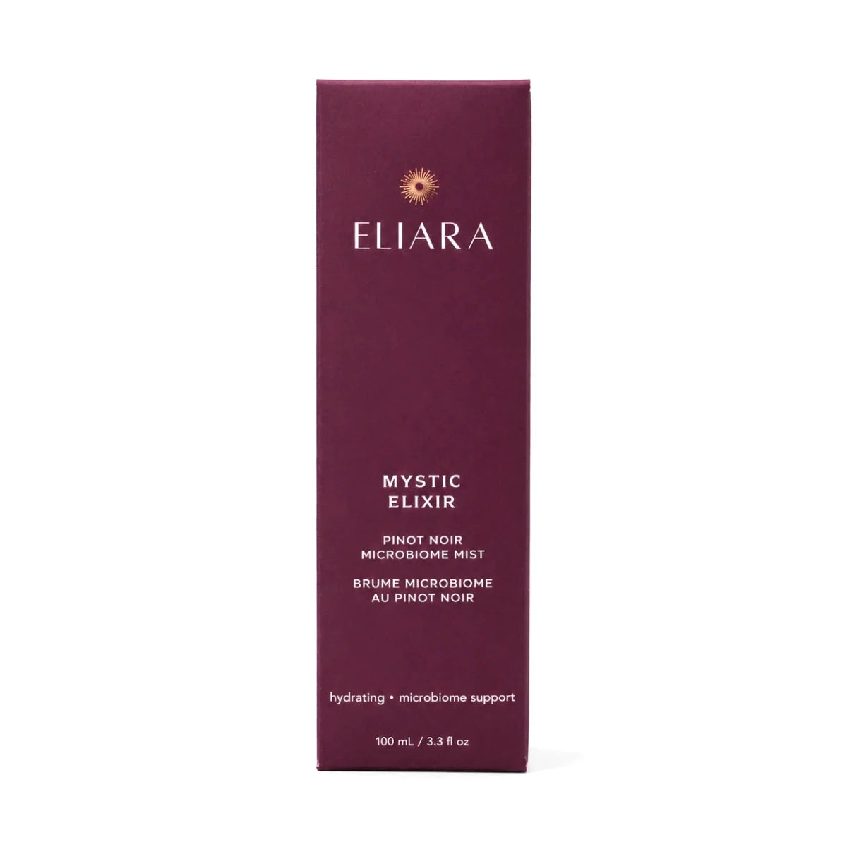 A tall, narrow rectangular box of Eliara Mystic Elixir on a plain white background. The packaging is a deep plum-purple color with white text and a small gold sunburst logo near the top.
