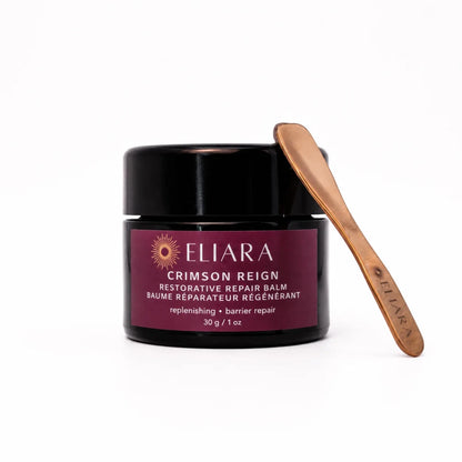 Eliara Crimson Reign restorative repair balm with a wooden applicator on a white background