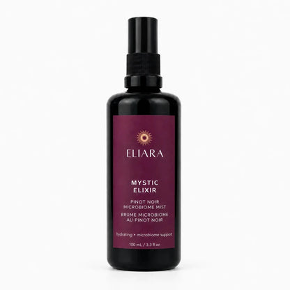A 100 ml black spray bottle of Eliara Mystic Elixir Pinot Noir microbiome mist, featuring a deep burgundy label with gold and white text, set against a clean white background.