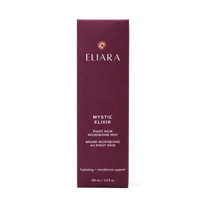 A tall, narrow rectangular box of Eliara Mystic Elixir on a plain white background. The packaging is a deep plum-purple color with white text and a small gold sunburst logo near the top.